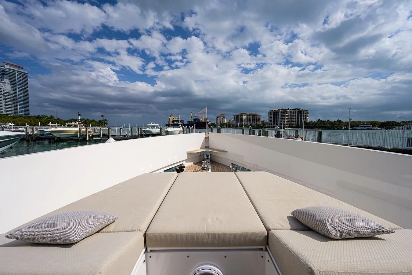 a large white pool with a city in the background aboard SOCIAL DISTANCING Yacht for Sale