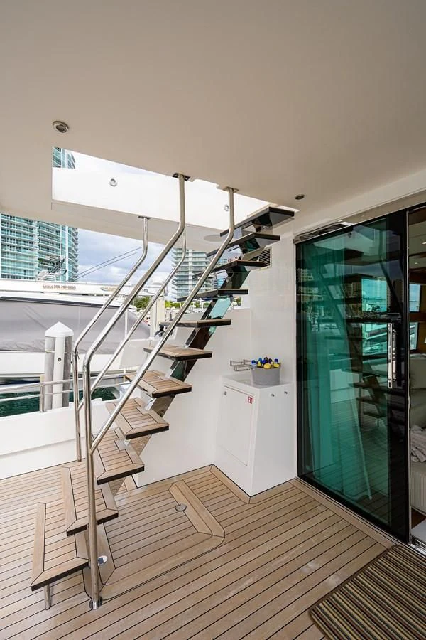 a white kitchen with a glass door aboard SOCIAL DISTANCING Yacht for Sale