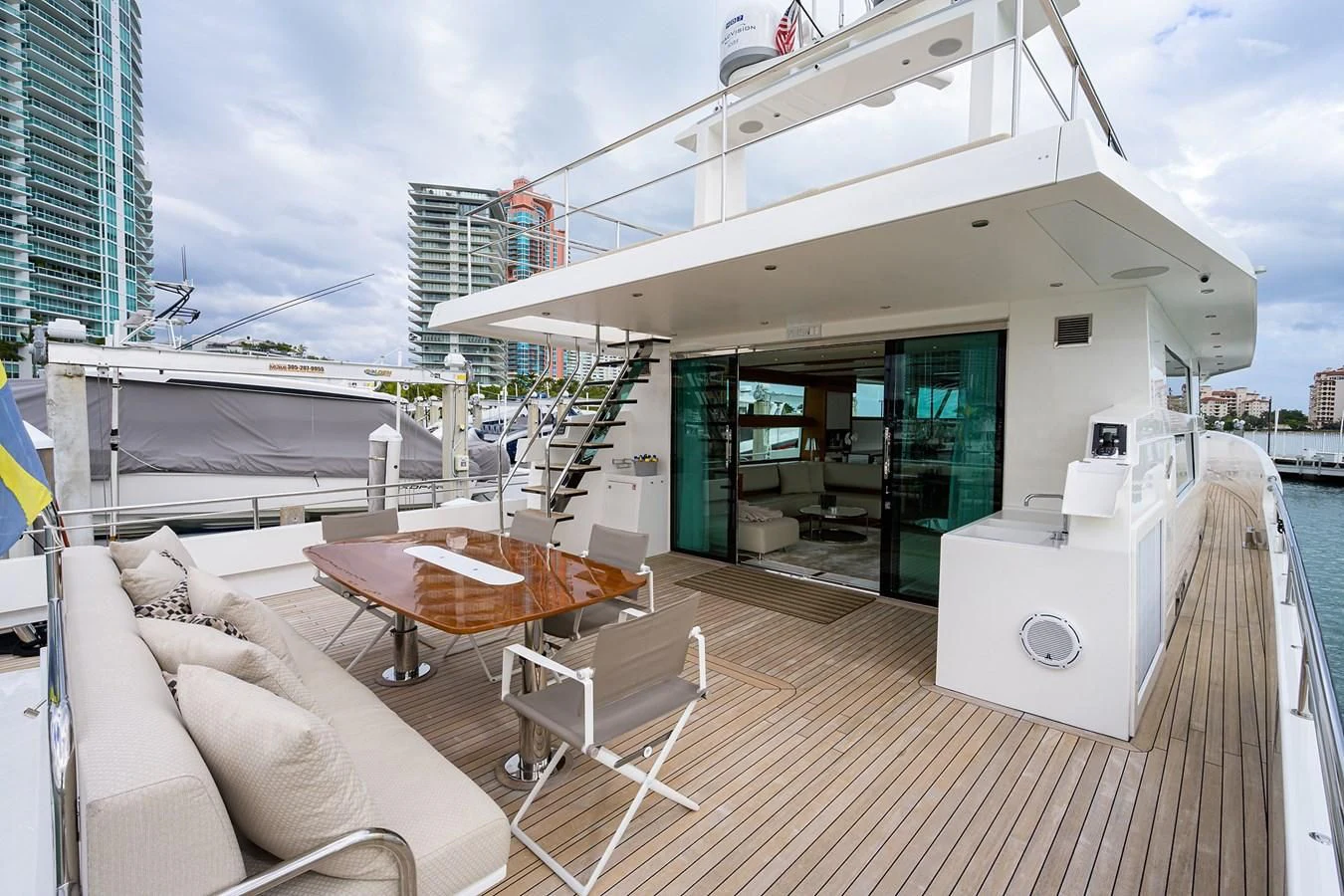 a deck with a table and chairs on it aboard SOCIAL DISTANCING Yacht for Sale