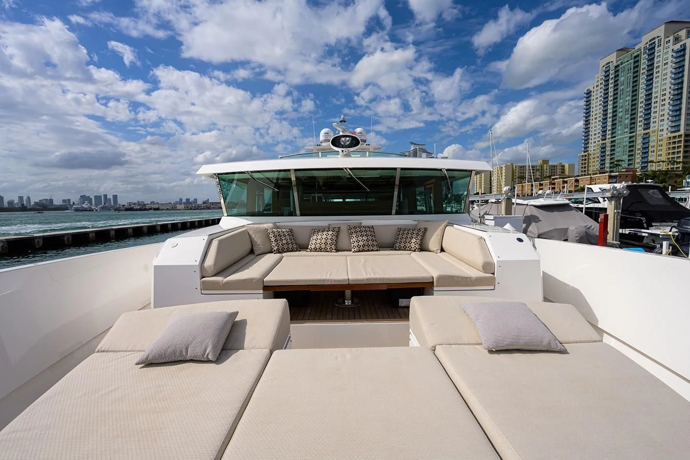 a lounge area with a building in the background aboard SOCIAL DISTANCING Yacht for Sale