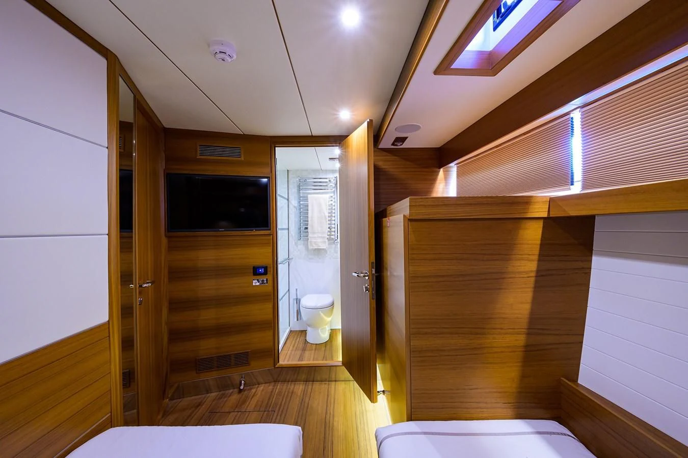 a bathroom with a toilet and a wooden door aboard SOCIAL DISTANCING Yacht for Sale