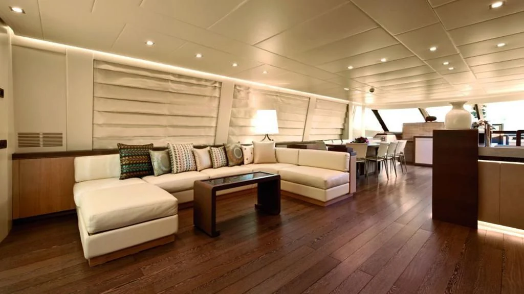 a living room with a couch and a table aboard MUSA Yacht for Sale
