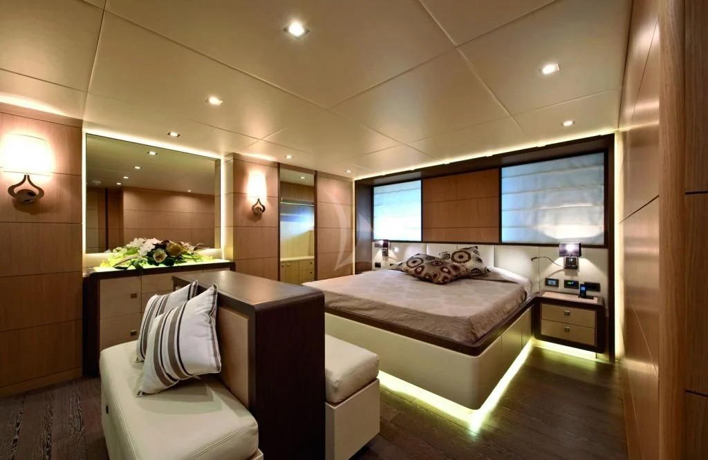 a room with a bed and a desk aboard MUSA Yacht for Sale