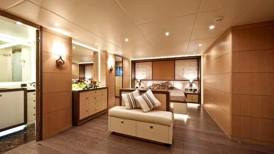 a room with a bed and a mirror aboard MUSA Yacht for Sale