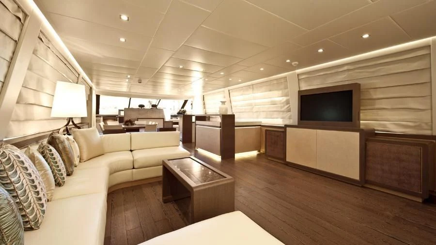 a living room with a large television aboard MUSA Yacht for Sale