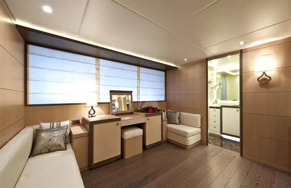a room with a bed and a desk aboard MUSA Yacht for Sale
