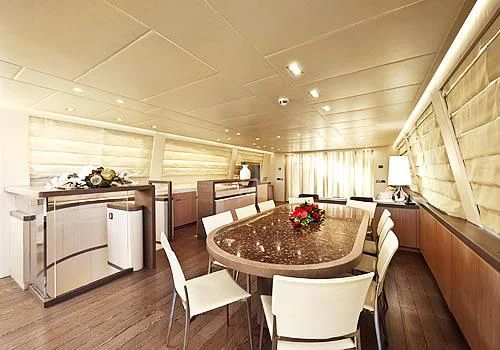 a room with a table chairs and a large window aboard MUSA Yacht for Sale