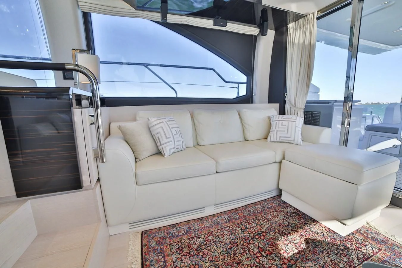 a living room with a couch and a window aboard SIRONA JOANNAH Yacht for Sale