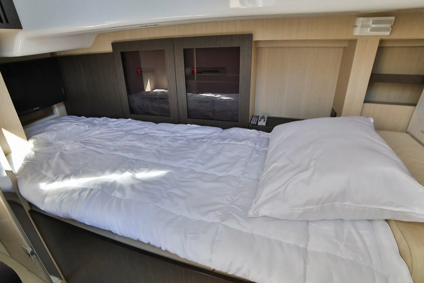 a bed with white sheets aboard SIRONA JOANNAH Yacht for Sale