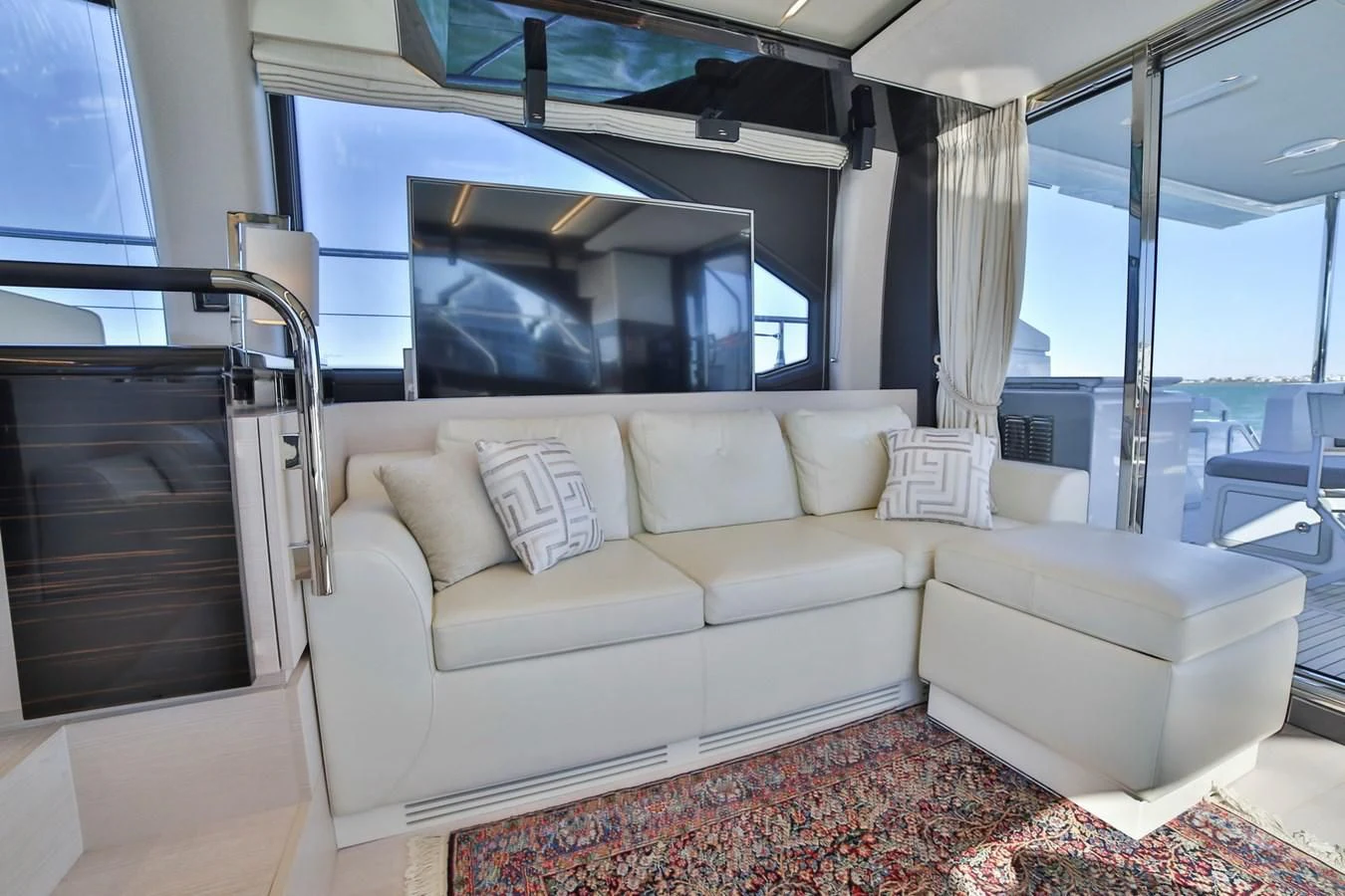 a living room with a couch and a window aboard SIRONA JOANNAH Yacht for Sale