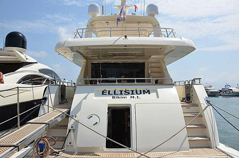 a white boat with a black hat on it aboard ELLISIUM Yacht for Sale