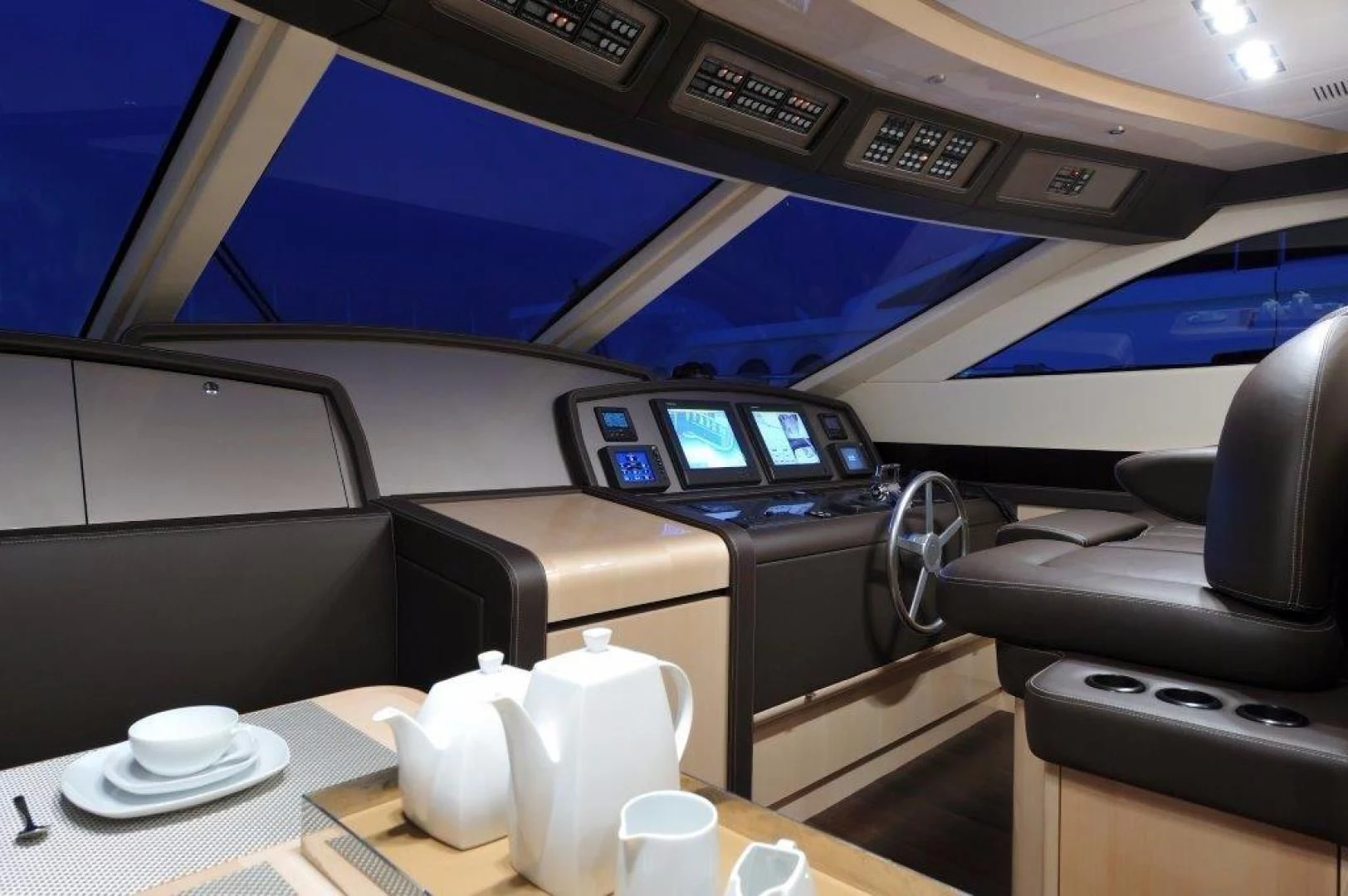 a plane with a screen and a desk with a laptop on it aboard ELLISIUM Yacht for Sale