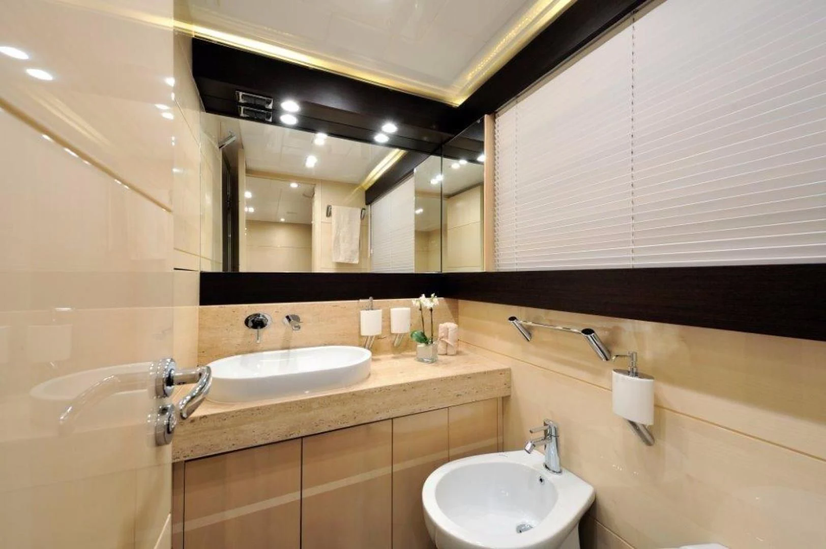 a bathroom with two sinks and a large mirror aboard ELLISIUM Yacht for Sale