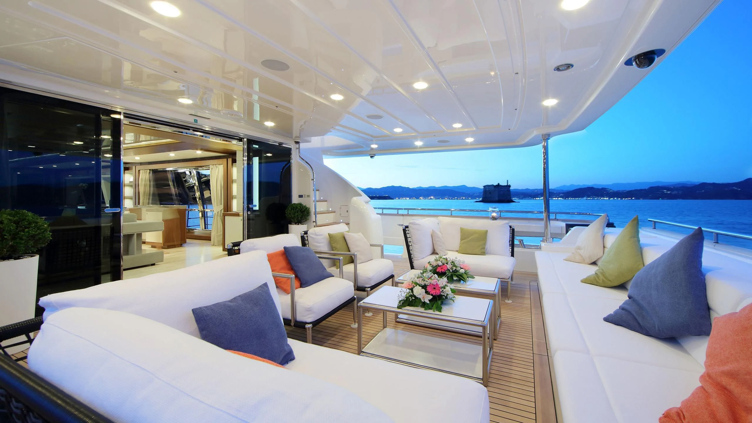 a room with a table chairs and a view of the ocean aboard VELA Yacht for Sale
