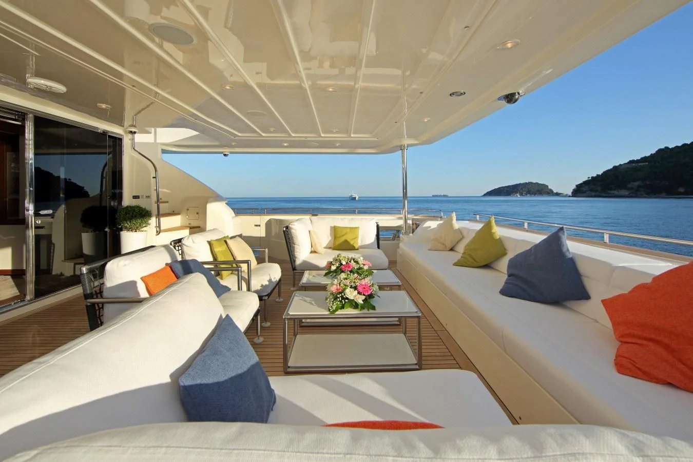 a room with a bed and chairs aboard VELA Yacht for Sale