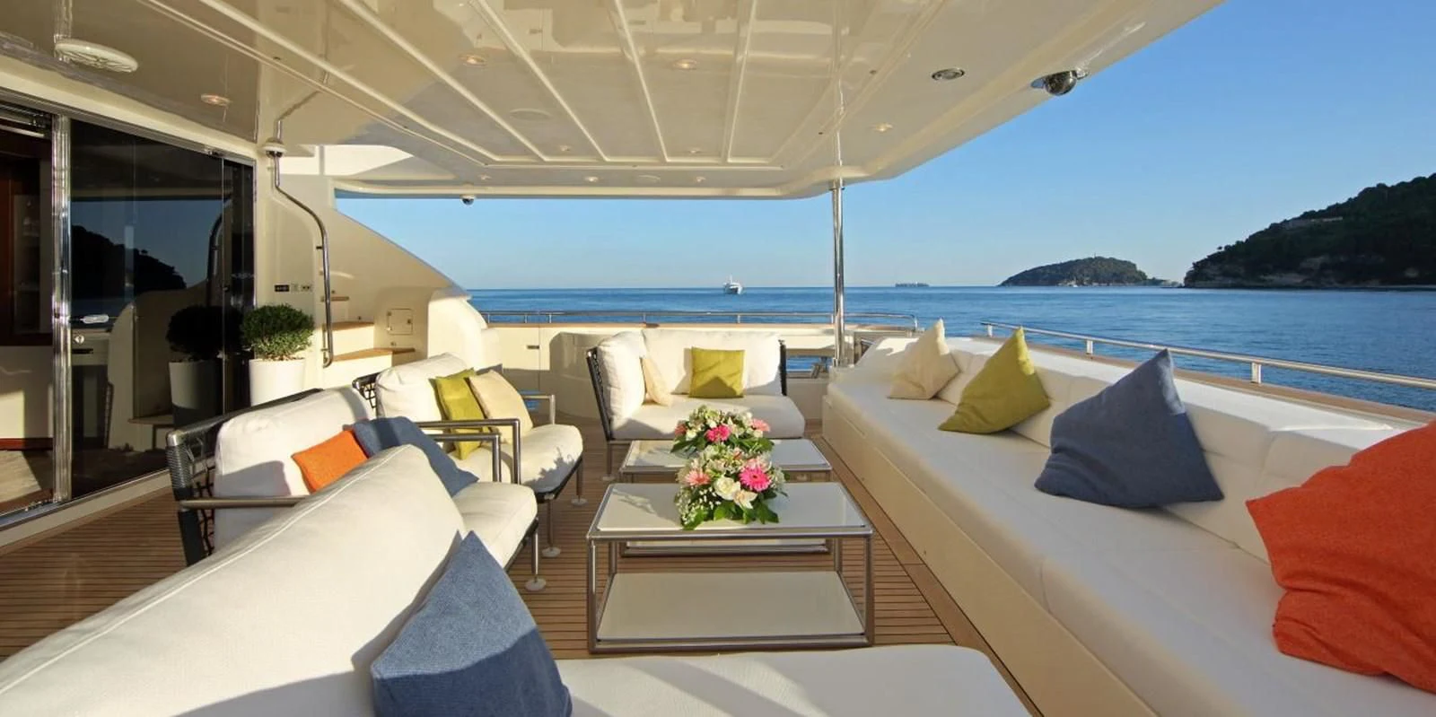 a room with a table and chairs aboard VELA Yacht for Sale