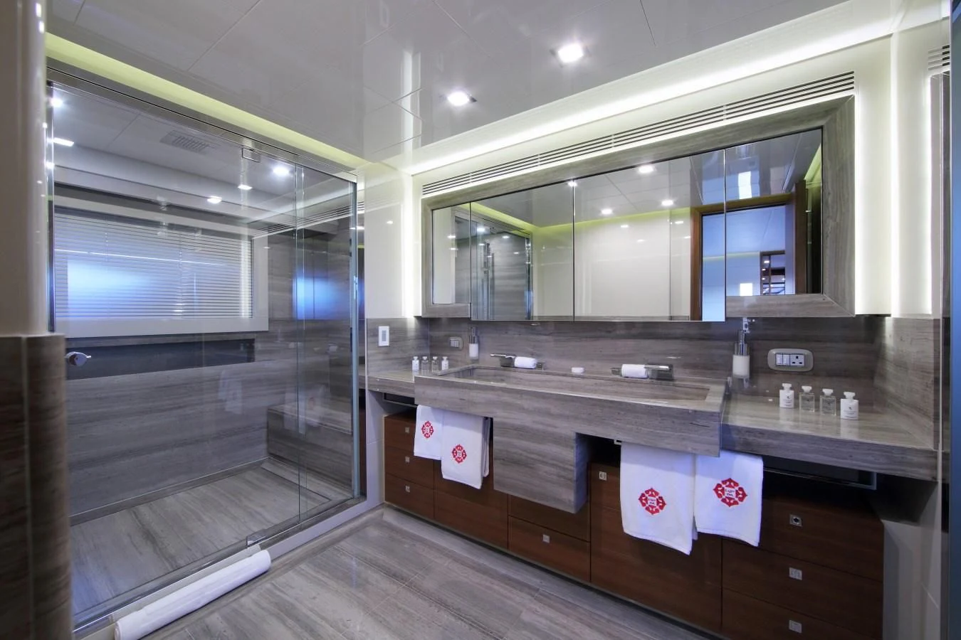 a bathroom with a glass shower aboard VELA Yacht for Sale