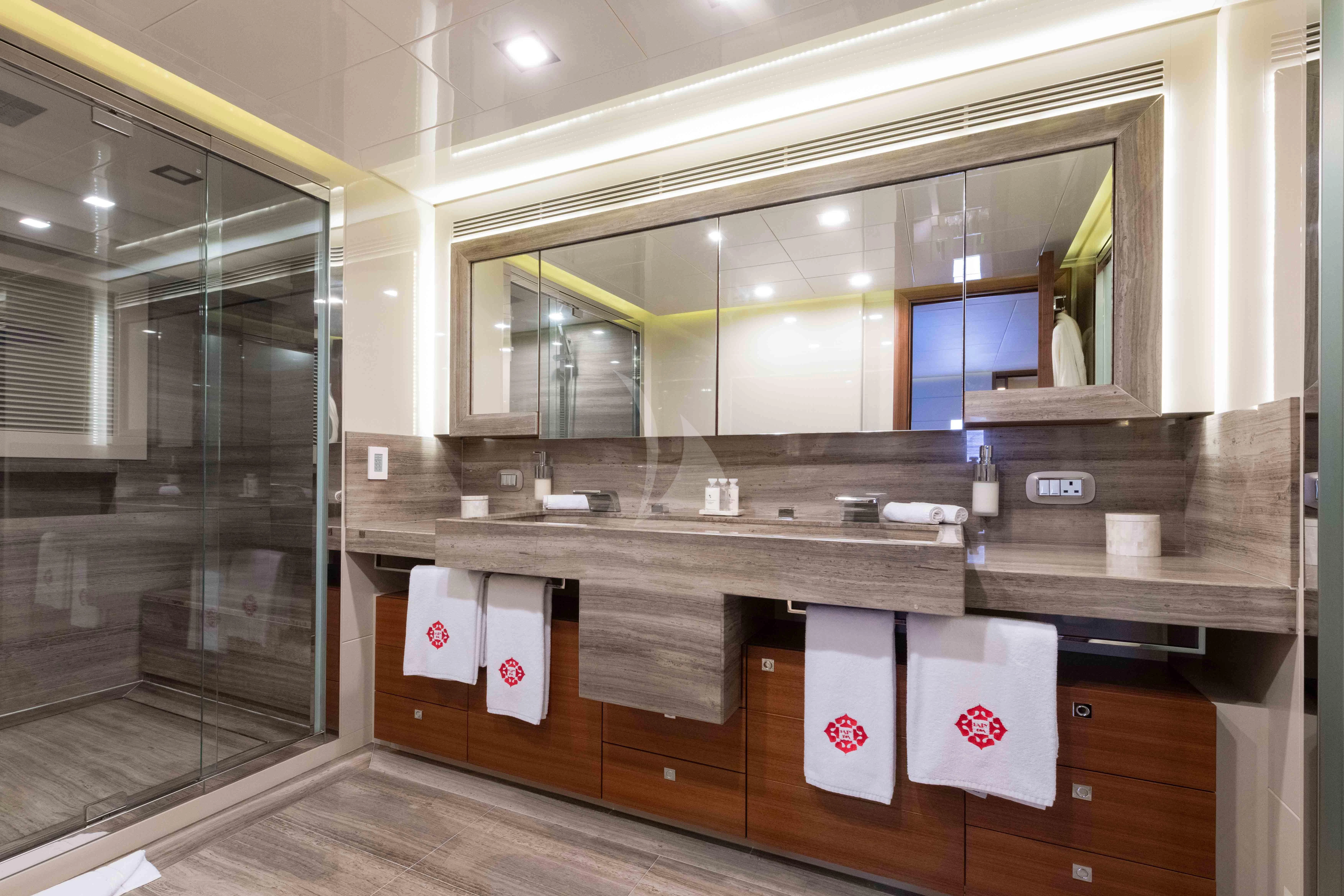 a bathroom with a glass shower aboard VELA Yacht for Sale