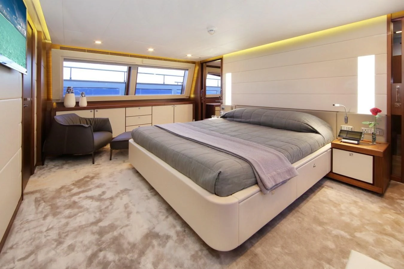 a bedroom with a bed and a couch aboard VELA Yacht for Sale