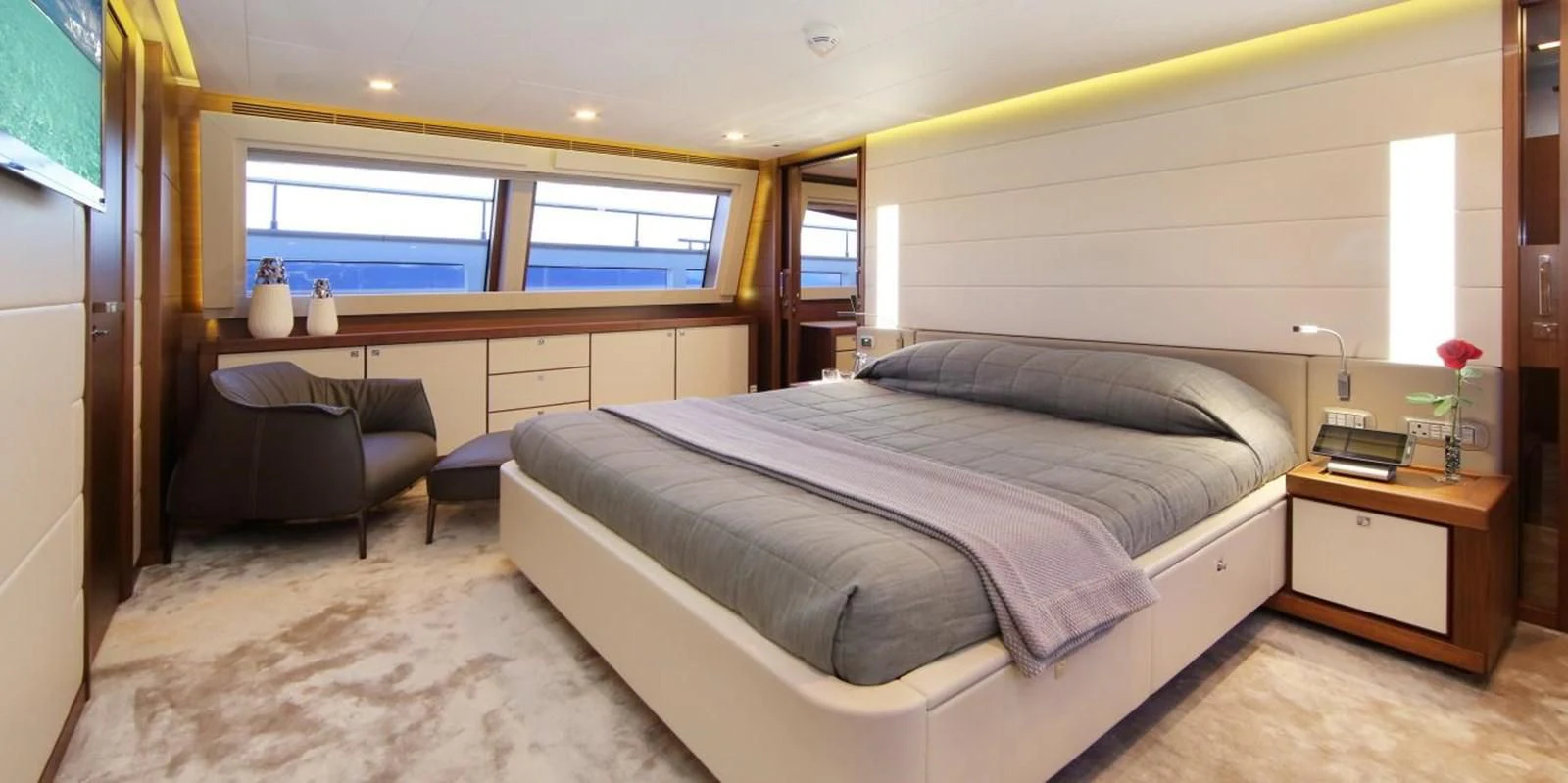 a bedroom with a bed and a couch aboard VELA Yacht for Sale
