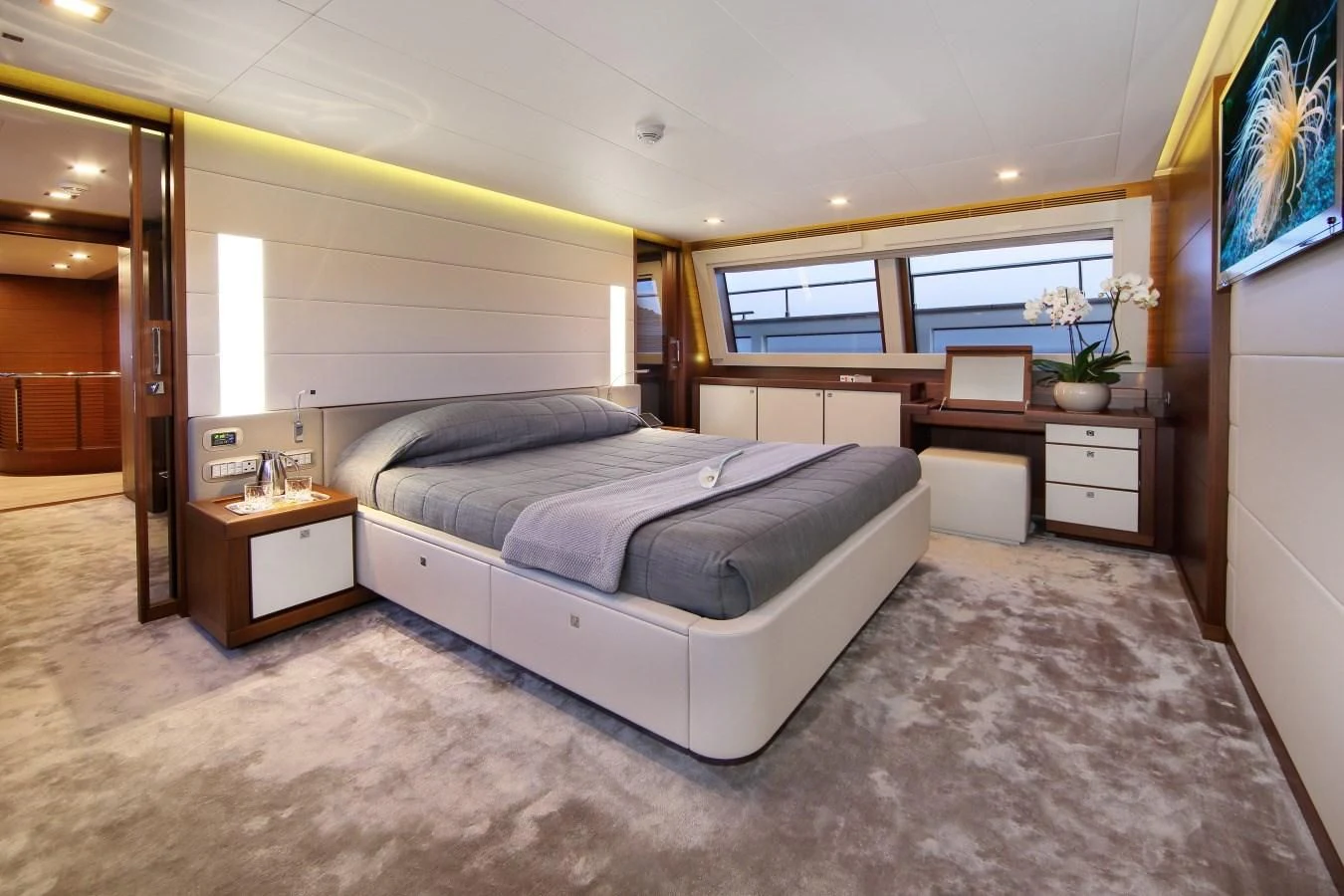 a bedroom with a bed and desk aboard VELA Yacht for Sale