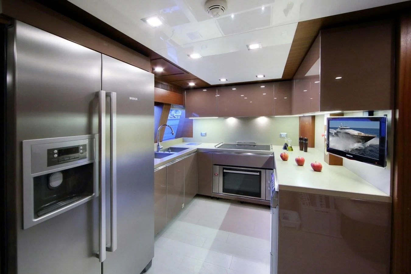 a kitchen with a refrigerator and microwave aboard VELA Yacht for Sale