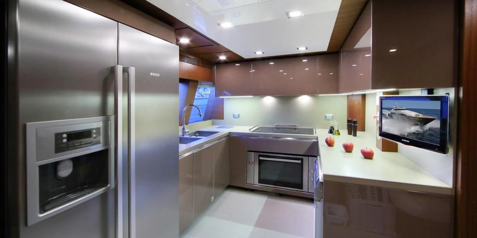 a kitchen with a refrigerator and microwave aboard VELA Yacht for Sale