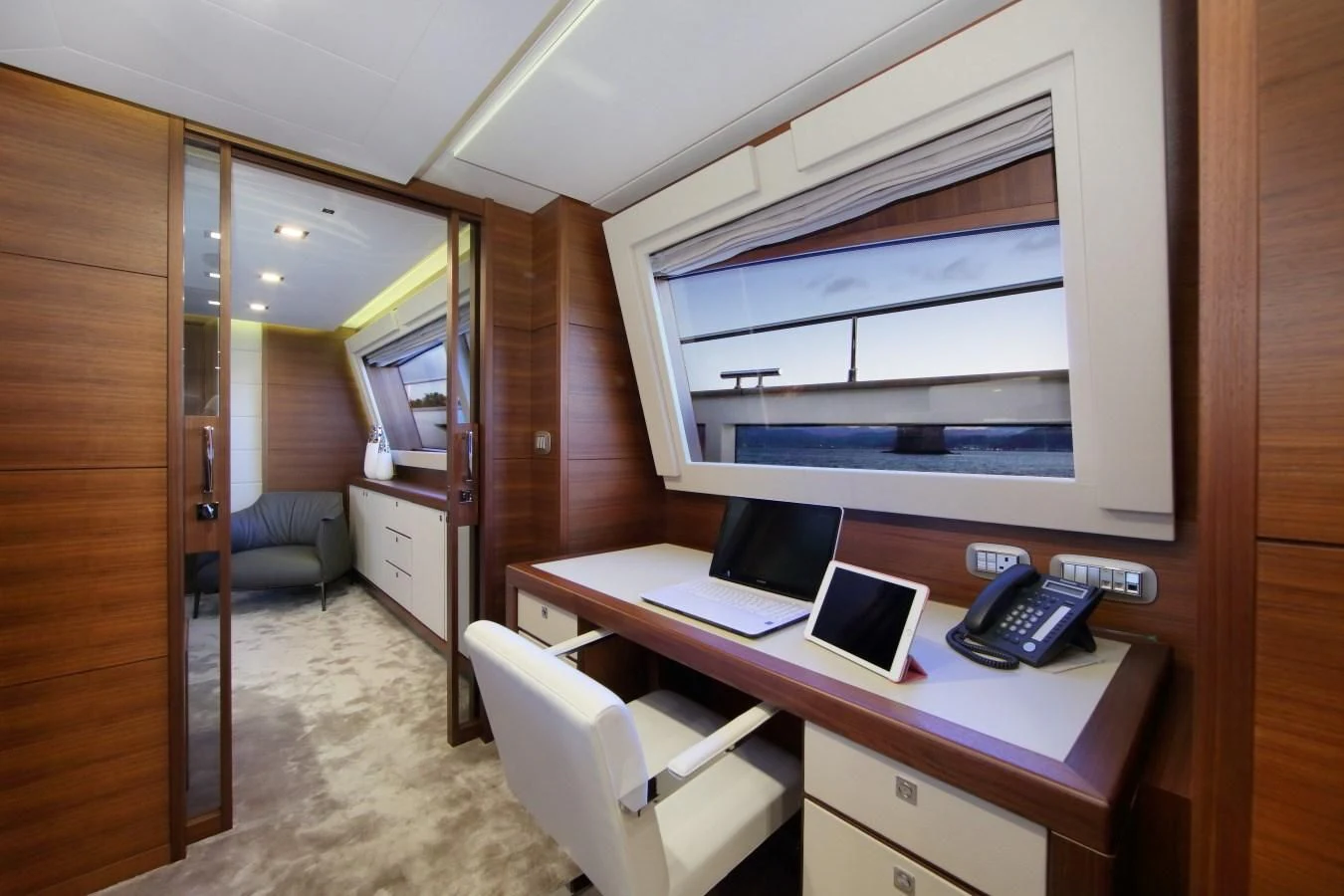 a room with a desk and a laptop aboard VELA Yacht for Sale