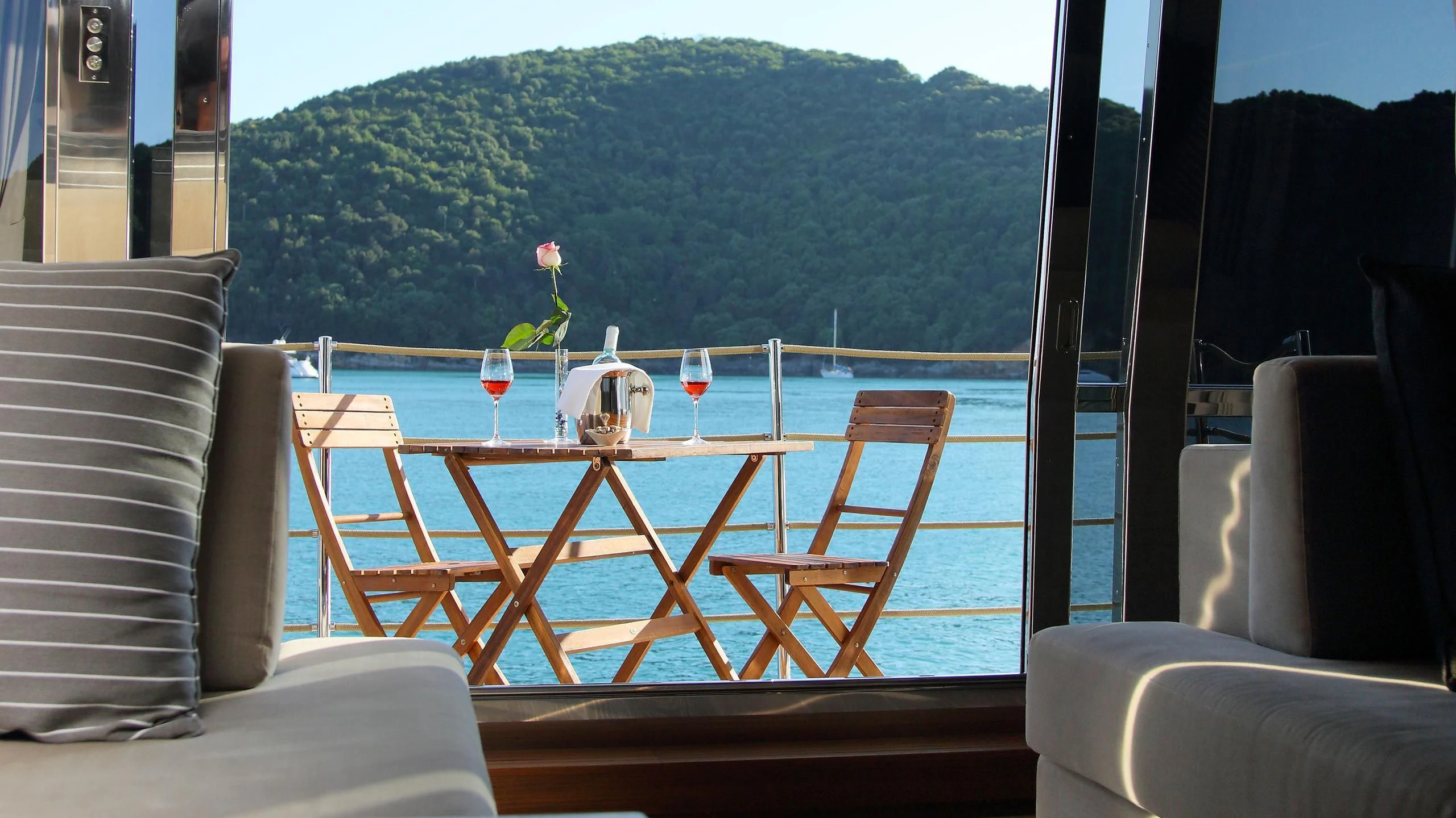 a table with candles on it aboard VELA Yacht for Sale