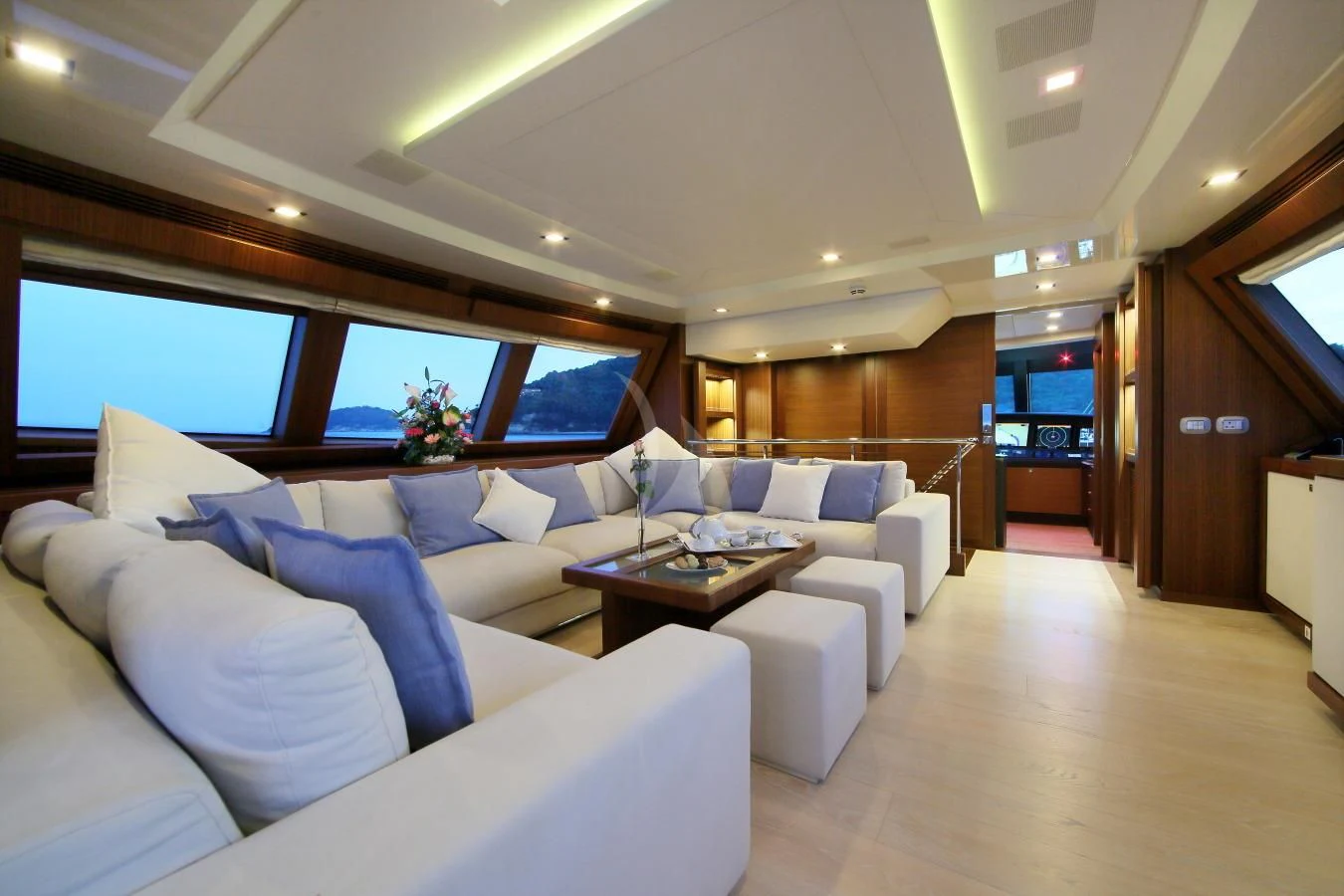 a room with a couch and a table aboard VELA Yacht for Sale