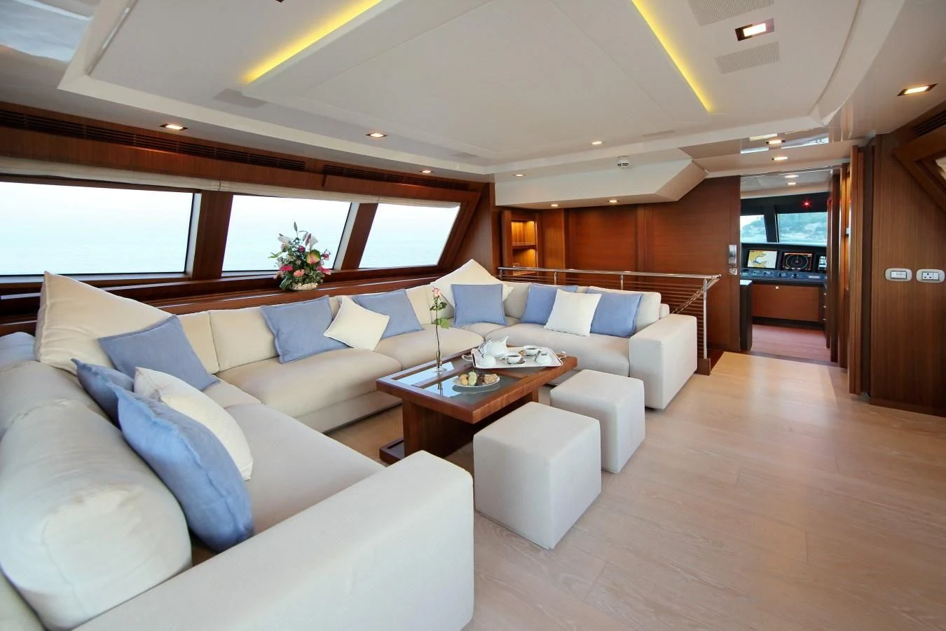 a living room with a couch and a table aboard VELA Yacht for Sale