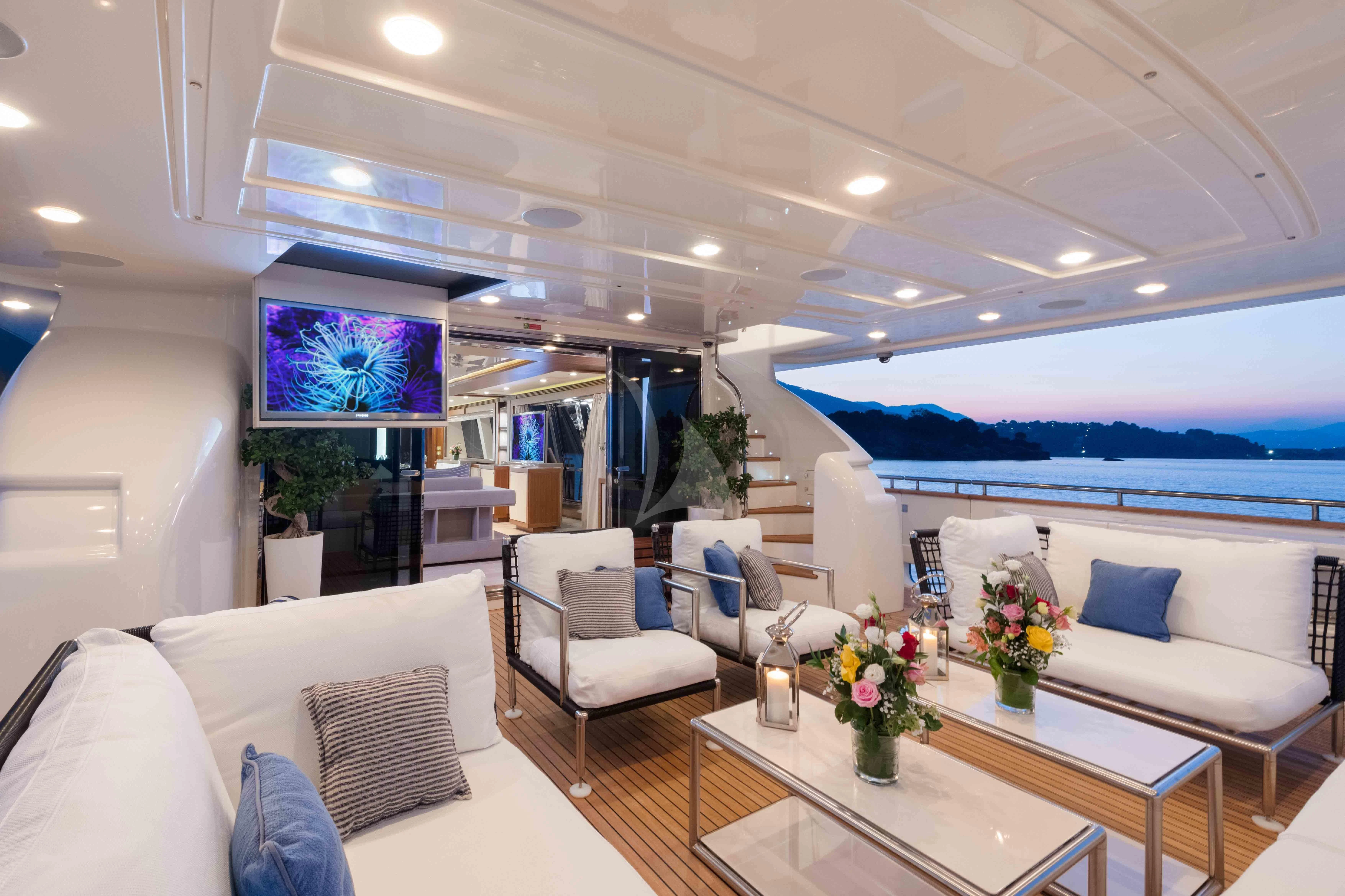 a living room with a table and chairs aboard VELA Yacht for Sale