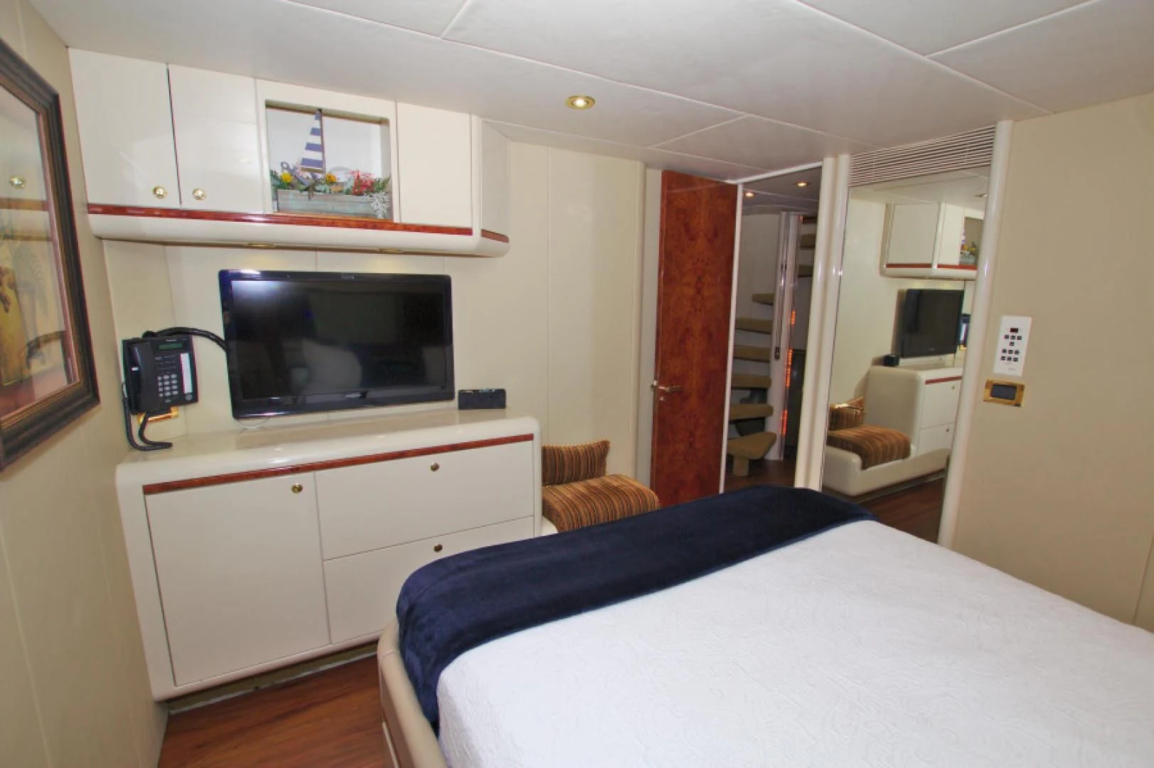 a bedroom with a bed and a television aboard CHRISTMAS SPIRIT Yacht for Sale