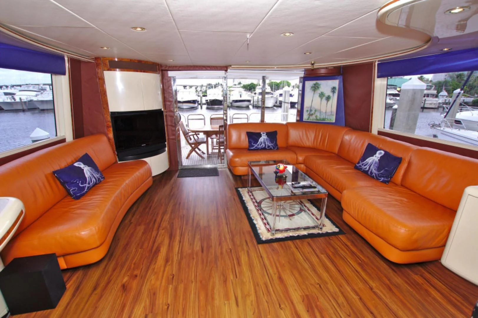 a living room with orange couches and a television aboard CHRISTMAS SPIRIT Yacht for Sale