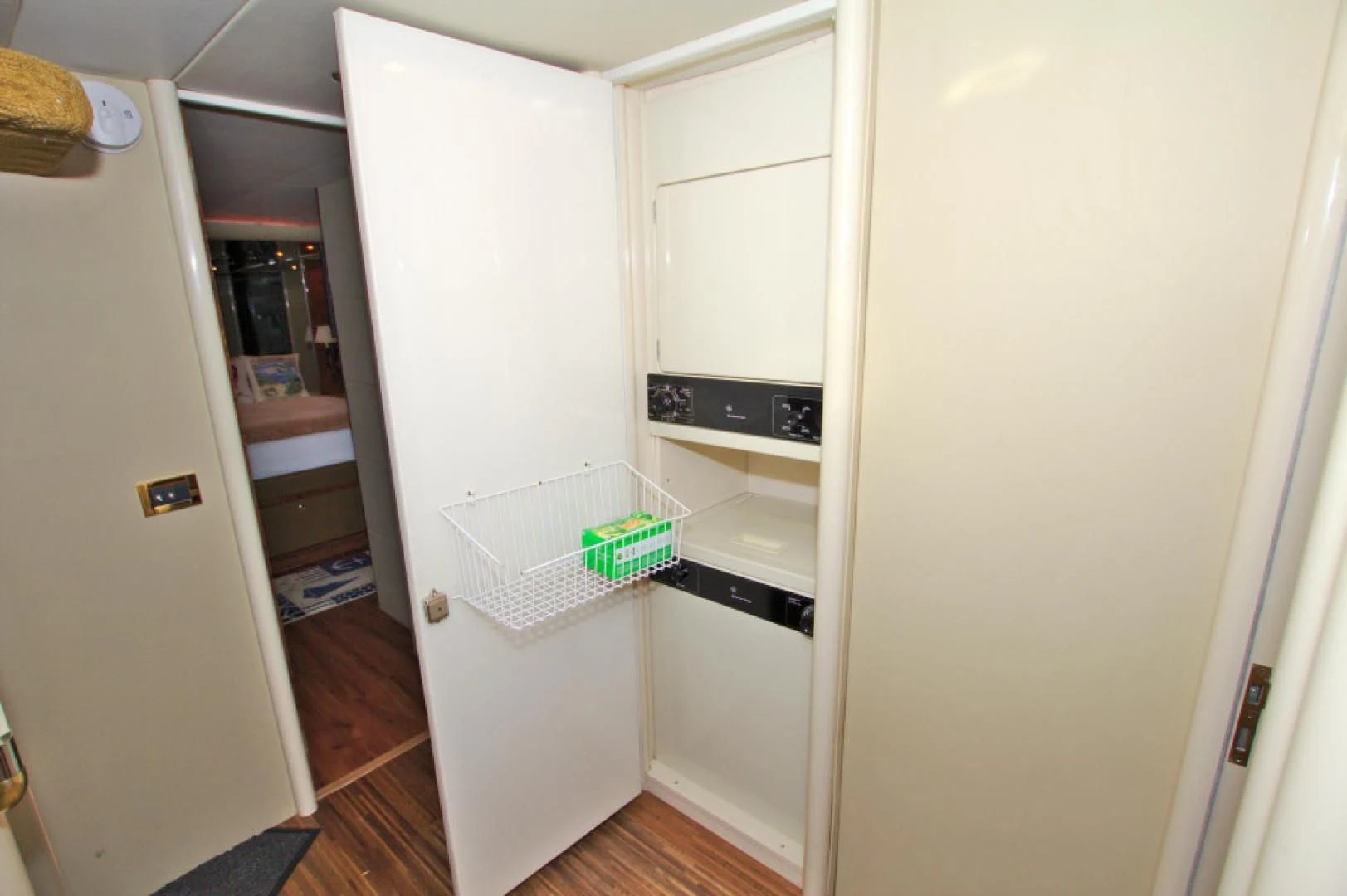 a small kitchen with a white refrigerator aboard CHRISTMAS SPIRIT Yacht for Sale