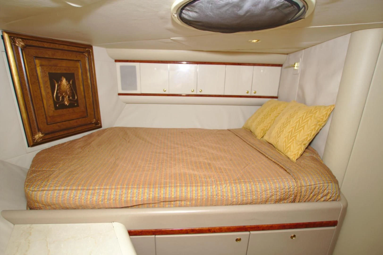 a bed with a painting on the wall aboard CHRISTMAS SPIRIT Yacht for Sale