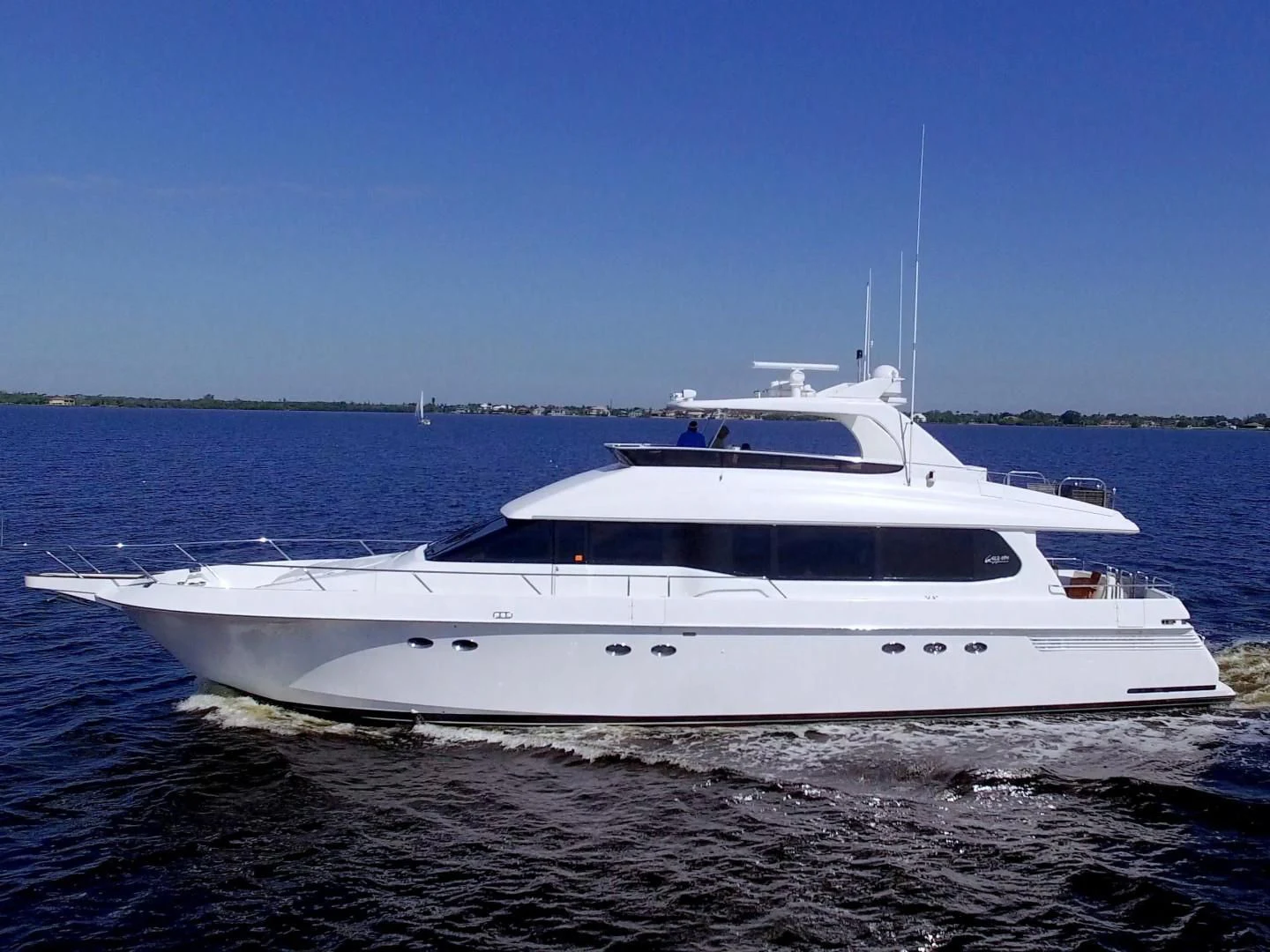 a white boat on a beach aboard CHRISTMAS SPIRIT Yacht for Sale