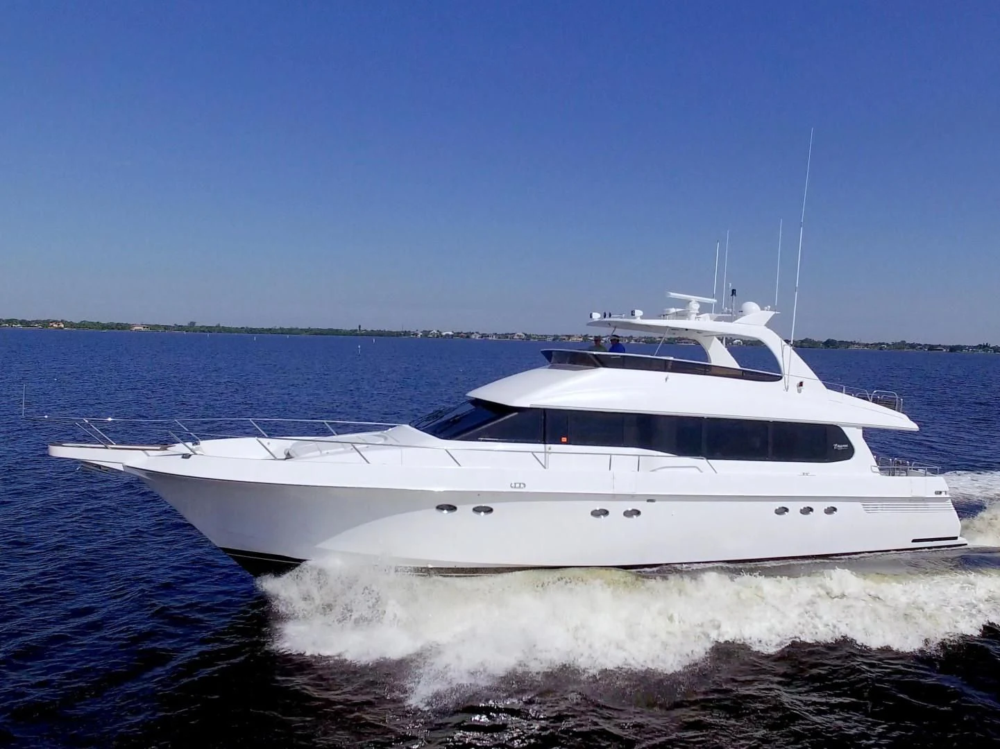 a white yacht on the water aboard CHRISTMAS SPIRIT Yacht for Sale