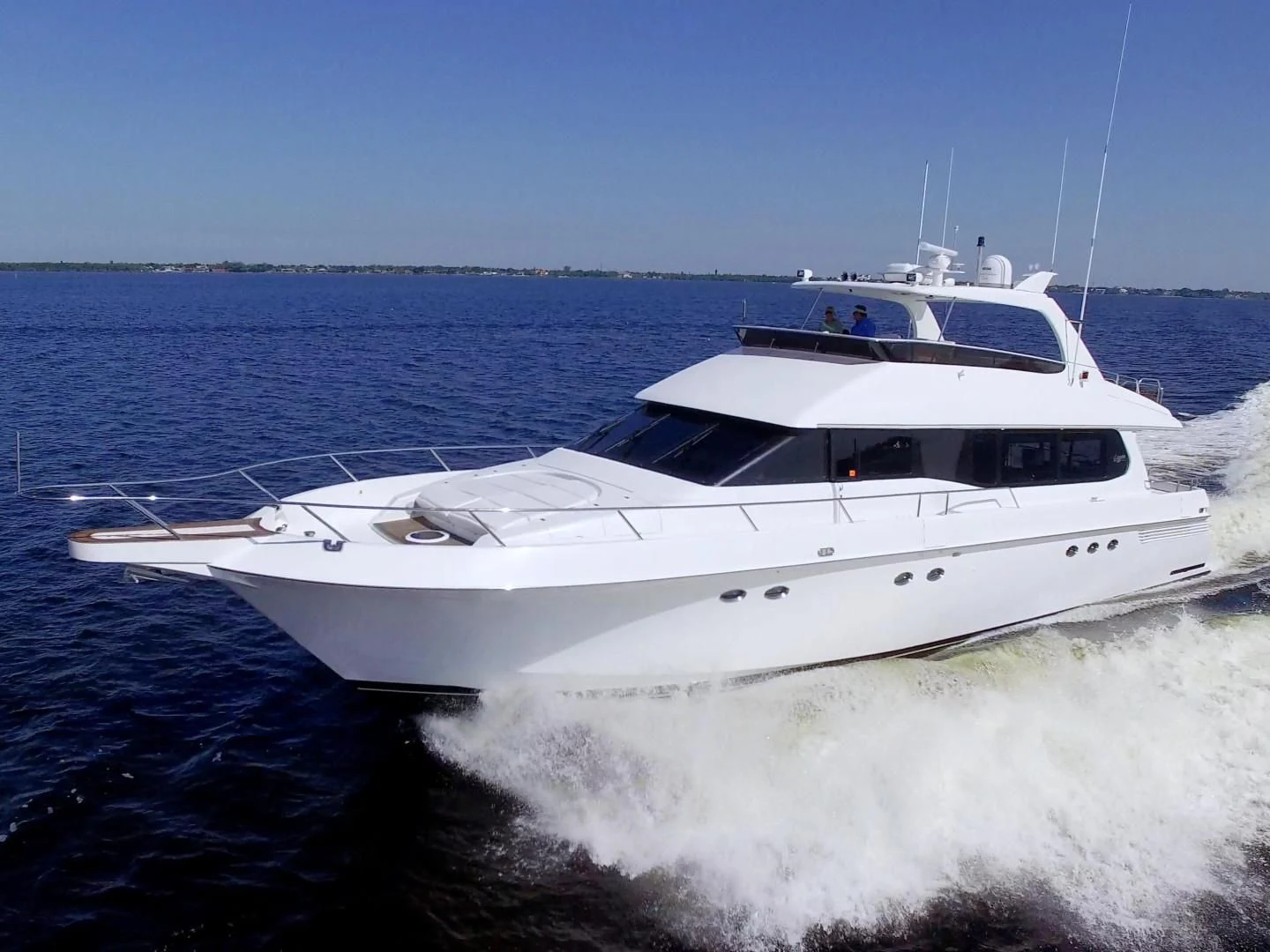 a white yacht on the water aboard CHRISTMAS SPIRIT Yacht for Sale