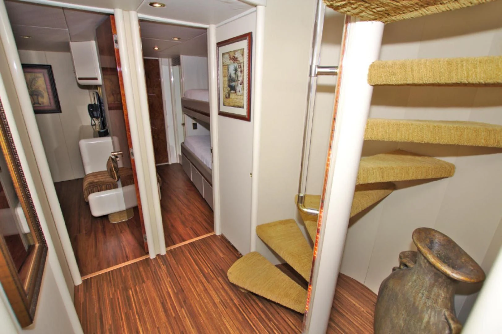 a room with a wood floor and a staircase aboard CHRISTMAS SPIRIT Yacht for Sale