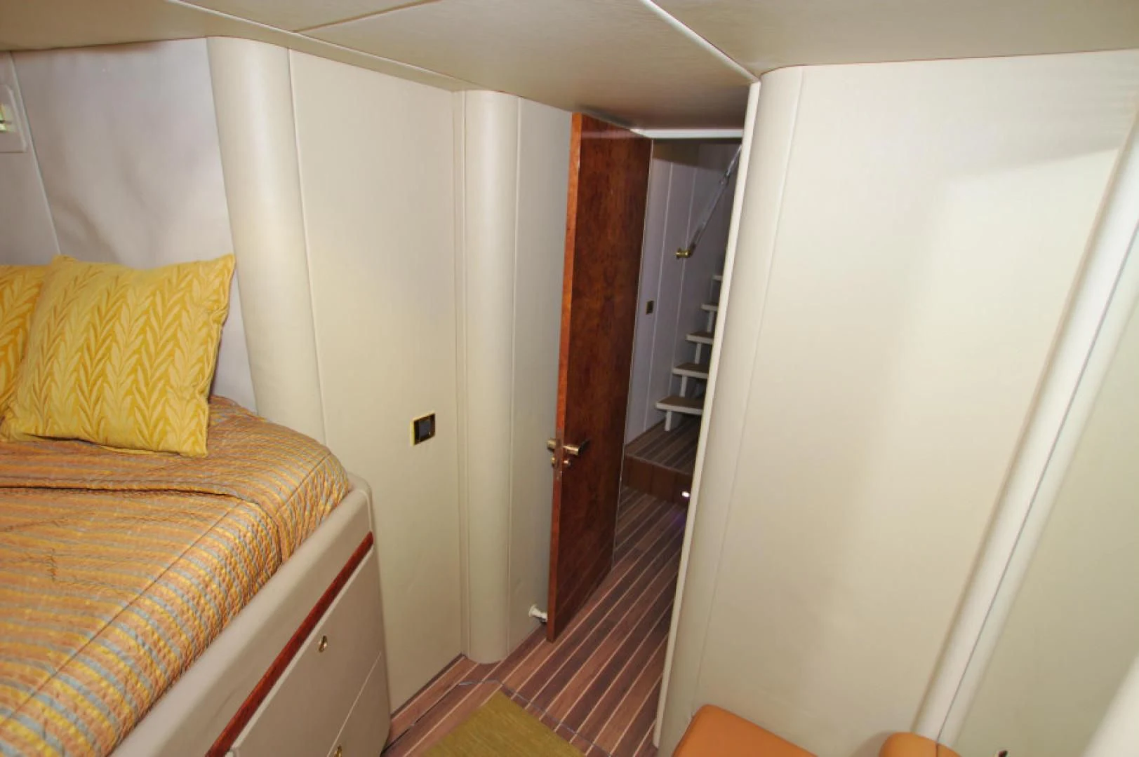 a bedroom with a bed and a door aboard CHRISTMAS SPIRIT Yacht for Sale