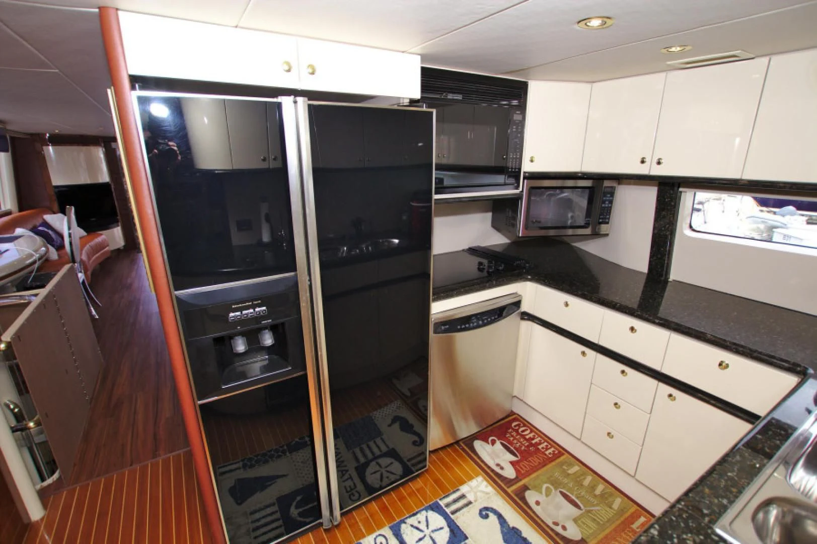 a kitchen with a large black refrigerator aboard CHRISTMAS SPIRIT Yacht for Sale