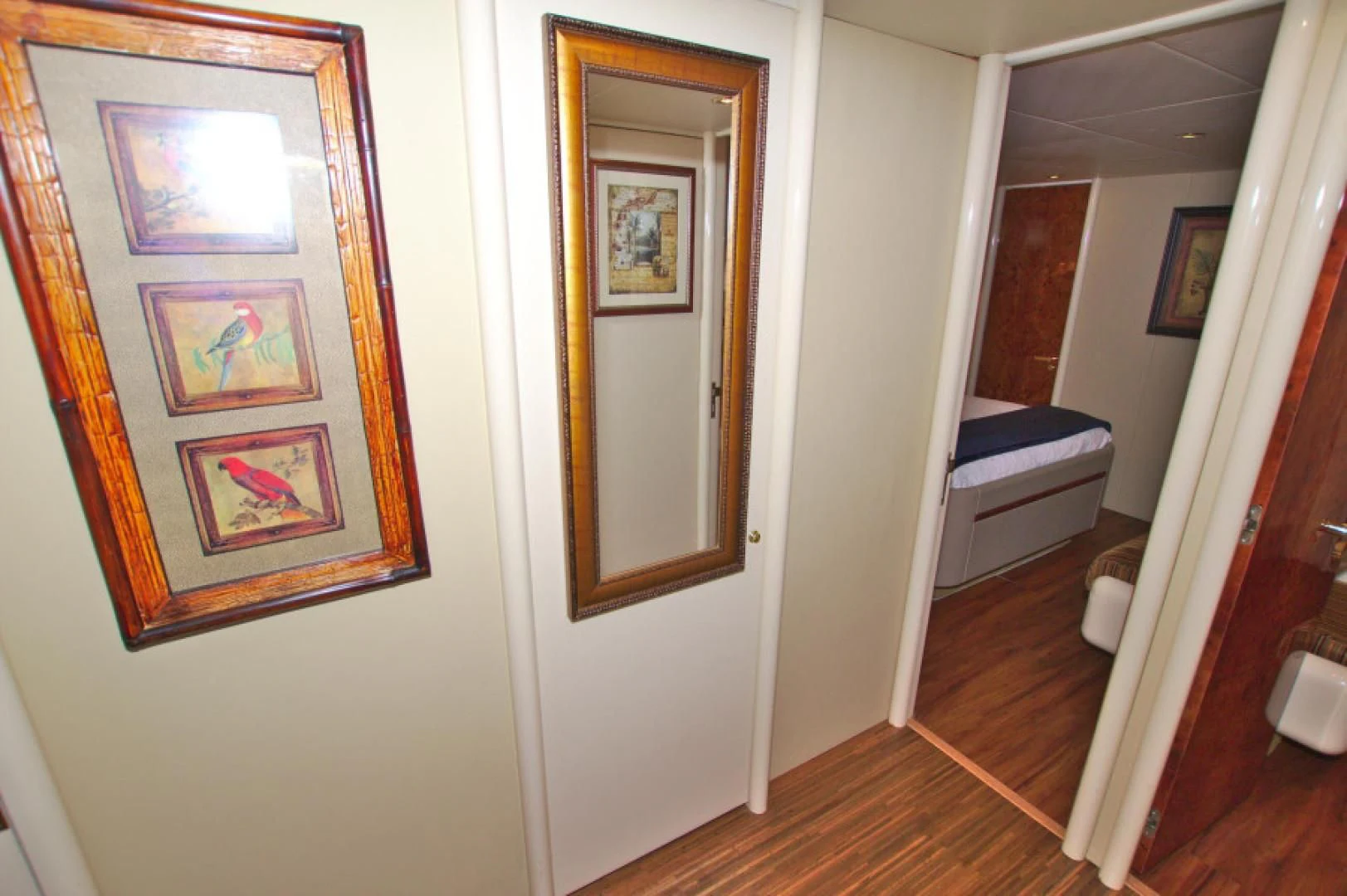 a hallway with a mirror and a bed aboard CHRISTMAS SPIRIT Yacht for Sale