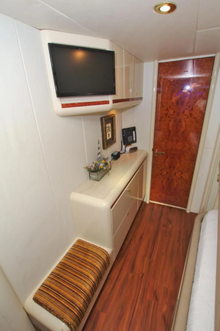 a small living room with a tv aboard CHRISTMAS SPIRIT Yacht for Sale