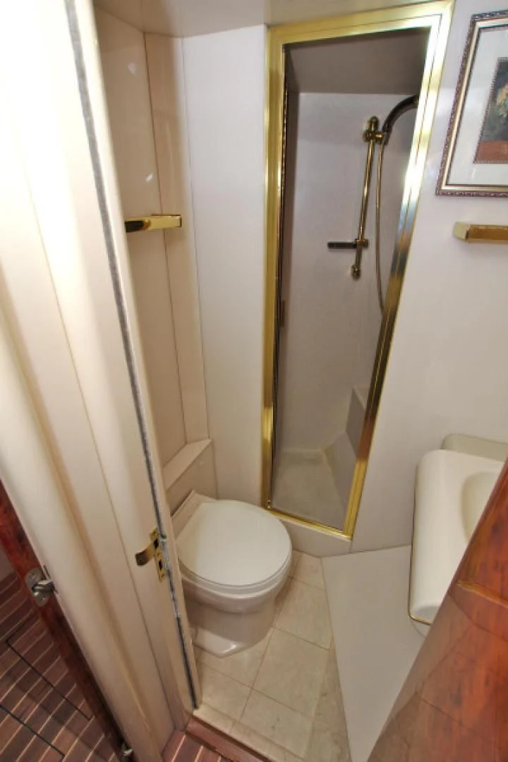 a bathroom with a toilet and a mirror aboard CHRISTMAS SPIRIT Yacht for Sale