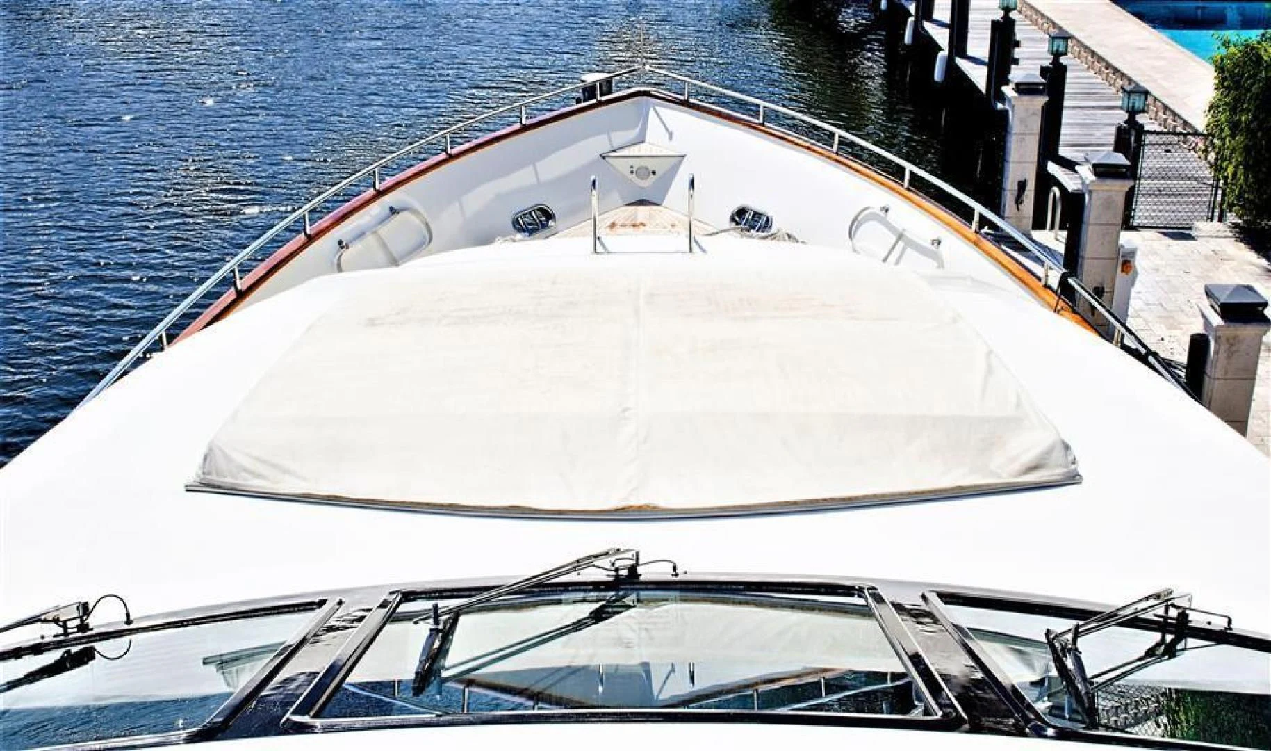 a white boat on a dock aboard CAROBELLE Yacht for Sale