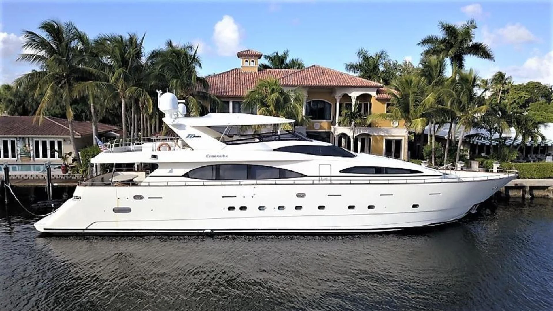 a white yacht on a dock aboard CAROBELLE Yacht for Sale