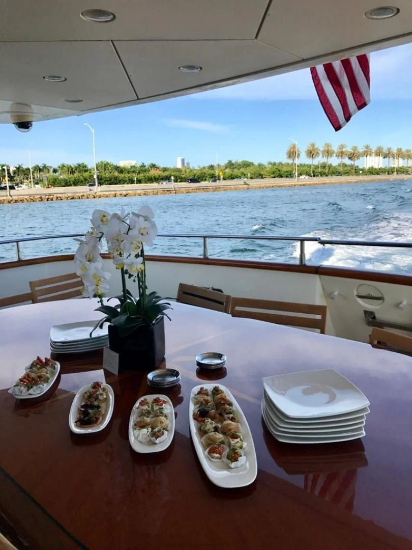 a table with plates and flowers on it aboard CAROBELLE Yacht for Sale