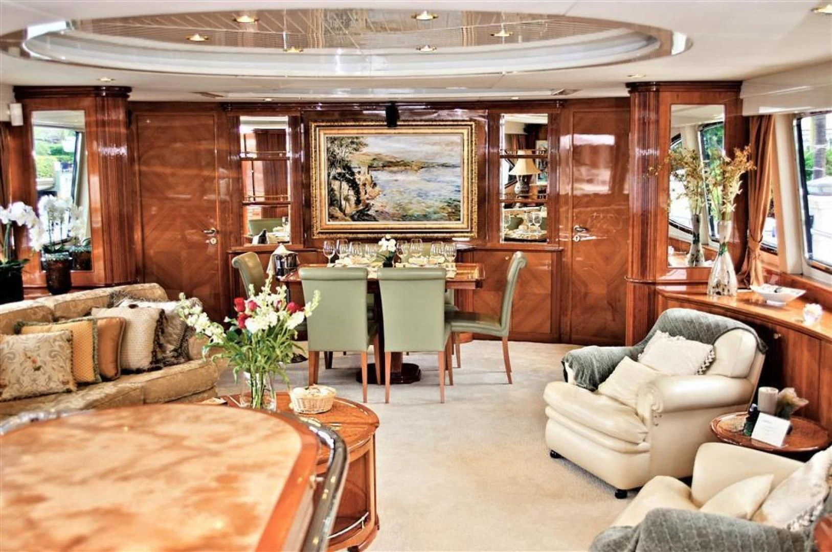 a living room with a table and chairs aboard CAROBELLE Yacht for Sale
