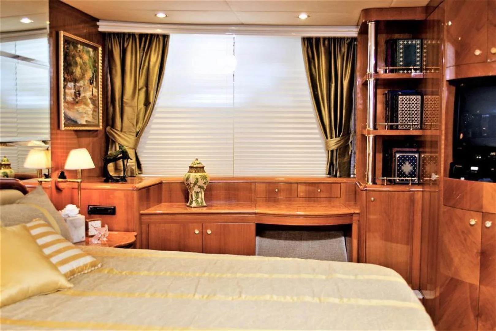 a bedroom with a bed and a book shelf aboard CAROBELLE Yacht for Sale